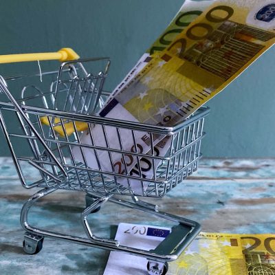 Background with a shopping cart and euro bills